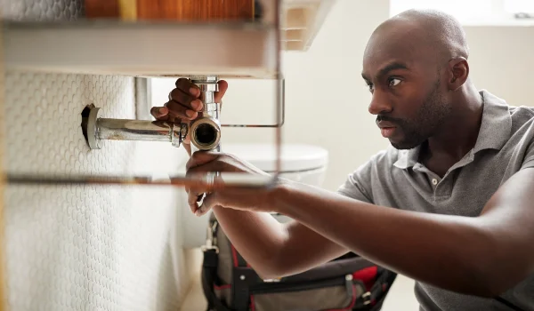 a male plumber fixing a bathroom faucet from EMERGENCY PLUMBER AUSTIN in Austin, TX - Austin, TX