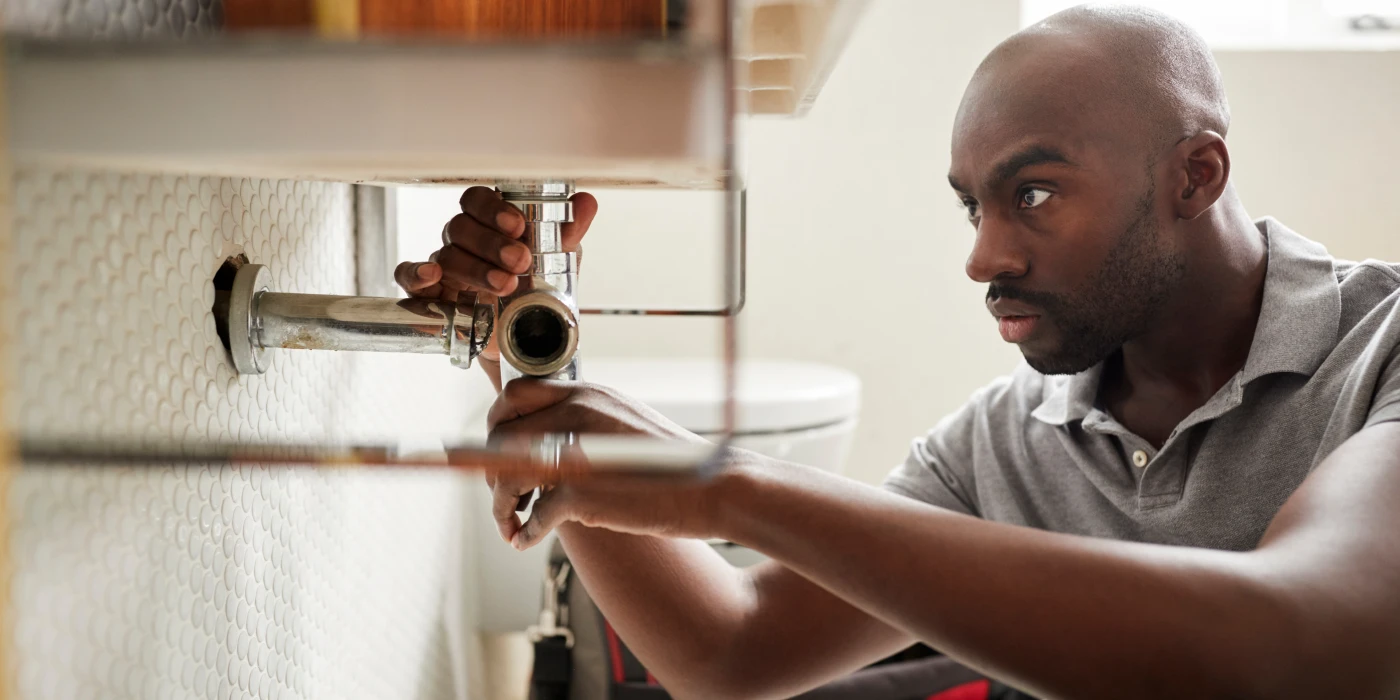 a male plumber fixing a pipe connection from Emergency Plumber Austin in Austin, TX 