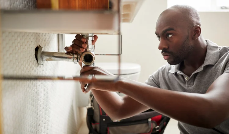 a male plumber fixing a pipe connection from Emergency Plumber Austin in Austin, TX 